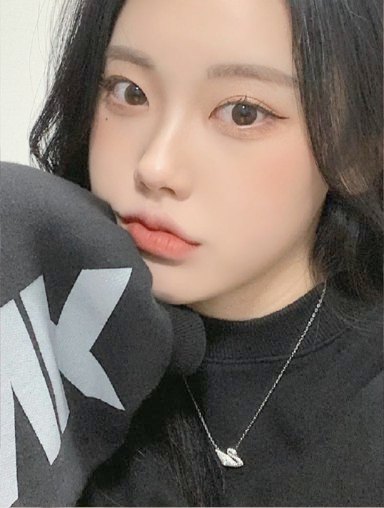Selfie of a woman in a black top facing forward