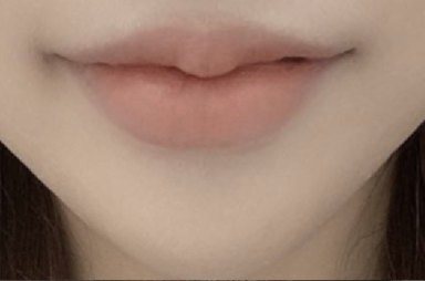 Close-up of lips with nude-tone lip color
