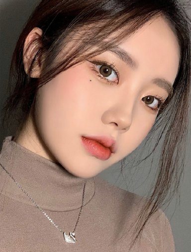 Selfie of a woman in a beige turtleneck facing forward
