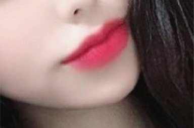 Close-up of red lips with a finger touching the cheek
