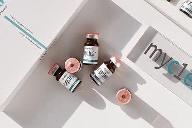 Empat vial cokelat Eraser Booster tersebar di atas latar putih